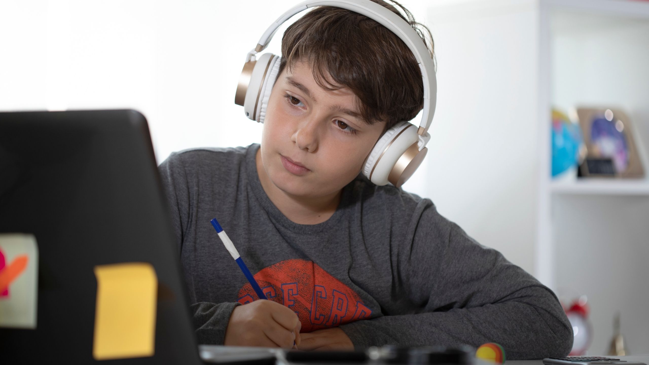Teen looking out over a city at night with a Bible nearby
